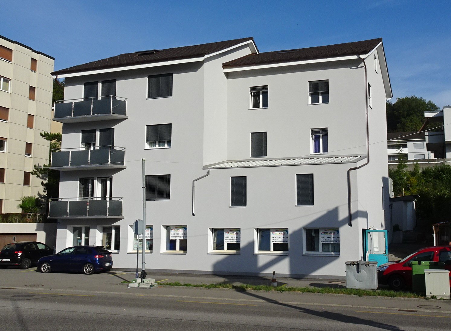 Modern building with 3 levels, glass windows, balconies, white paint, modern design, 3 balconies, black roof