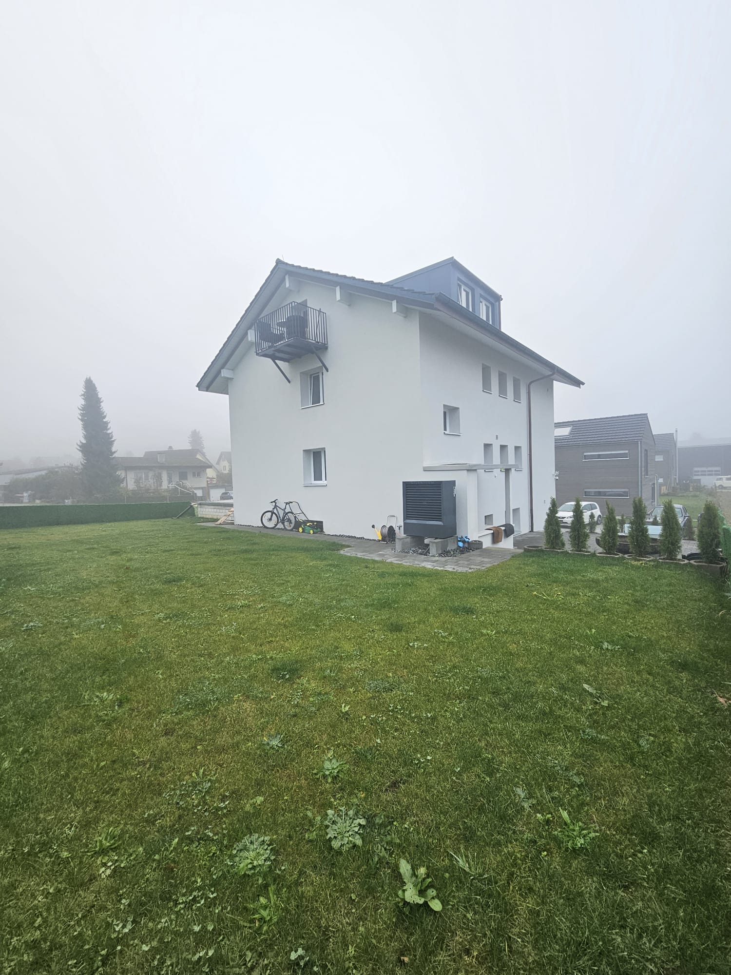 modern white house, two stories, balcony, backyard, green lawn