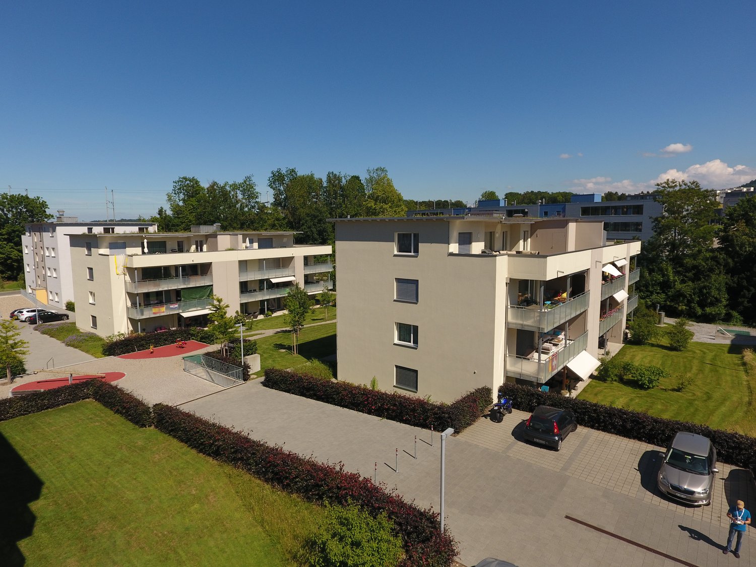 Apart building with balconies, parking area, greenery