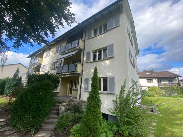 3-story house, white exterior, multiple balconies, well-maintained garden, multiple windows