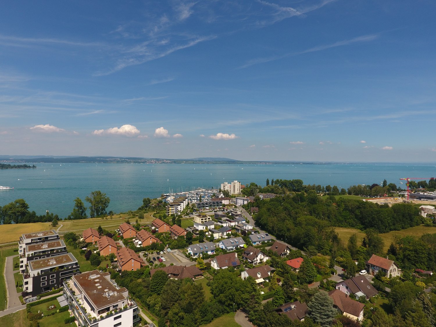 Several residential buildings with view of a large lake