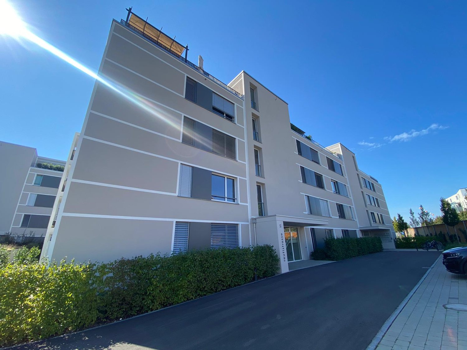 modern building with multiple floors, concrete exterior, many windows, balconies