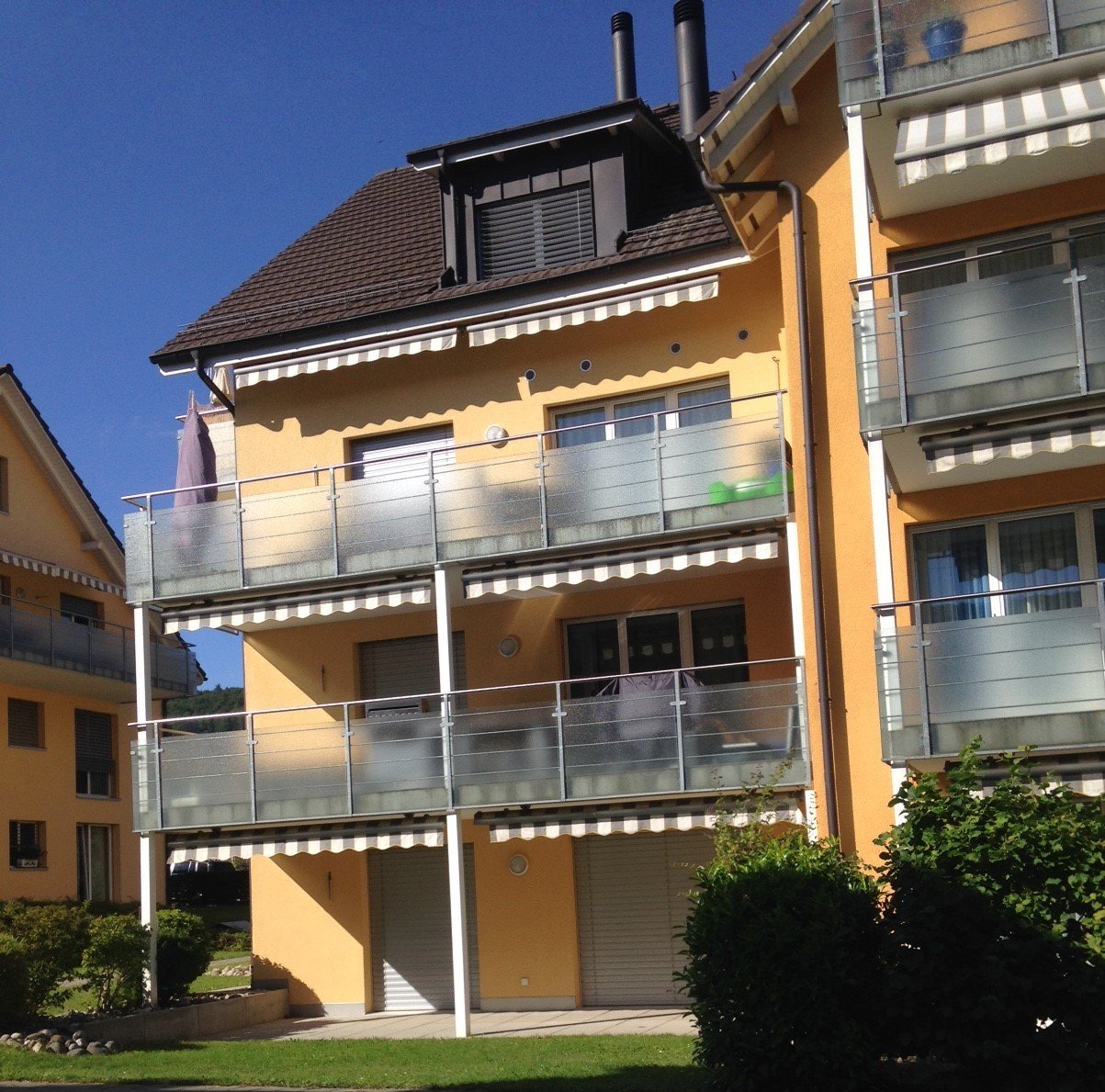 modern two story house, yellow painted, balconies, 2 garages