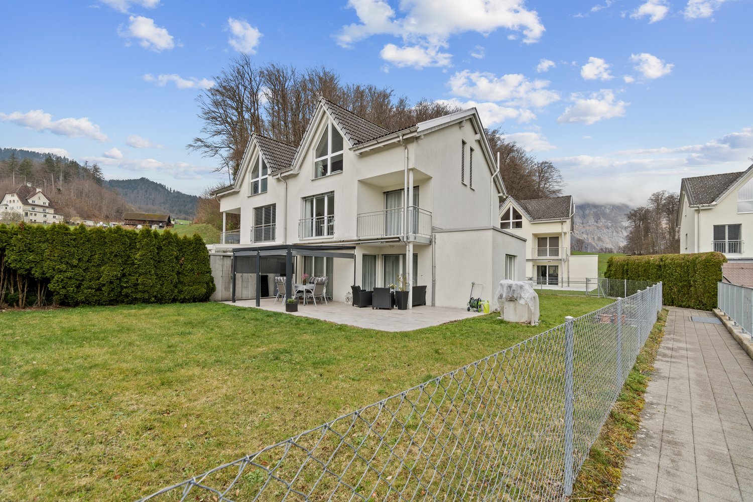 White modern house, 3 stories, terrace, garden, patio furniture