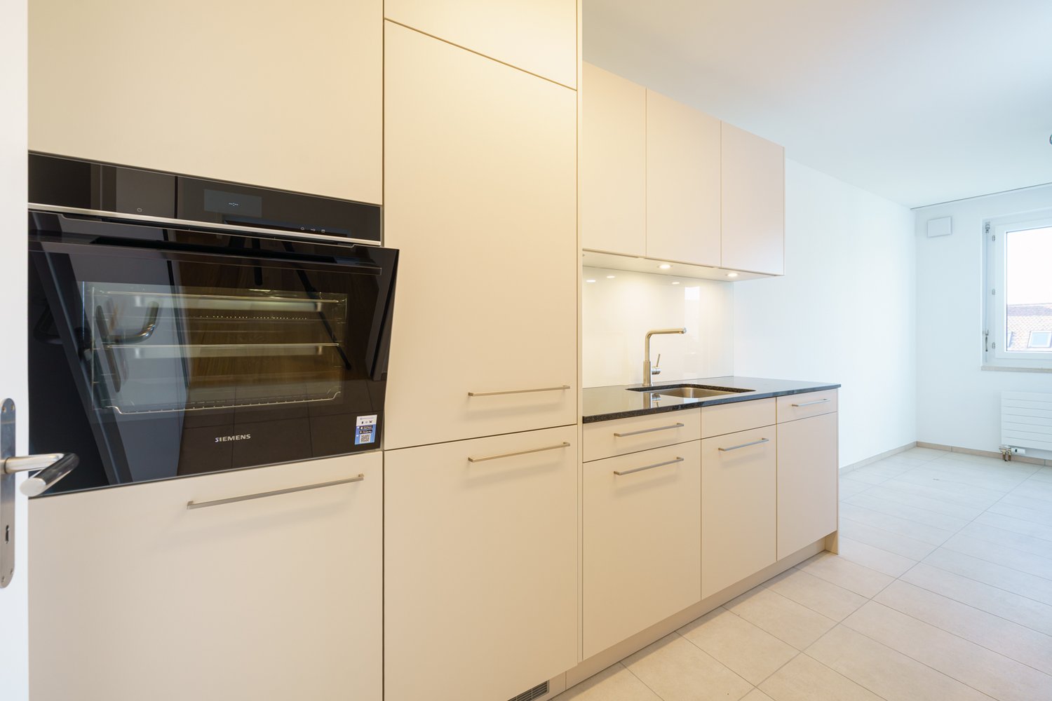 modern kitchen, stainless steel fridge, stove, dishwasher, sink, tiled floor