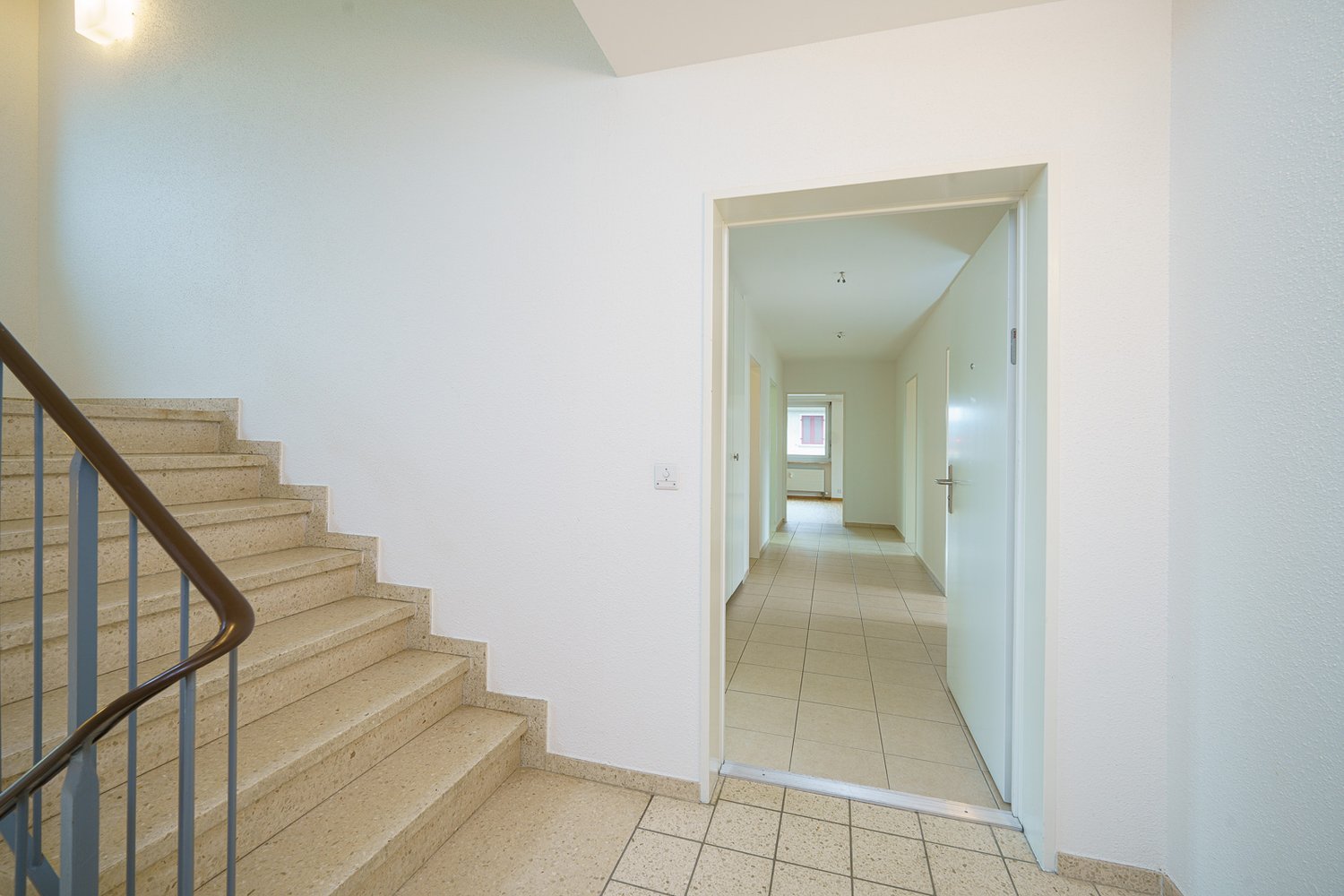 staircase, beige tiles, white walls, open door, white walls