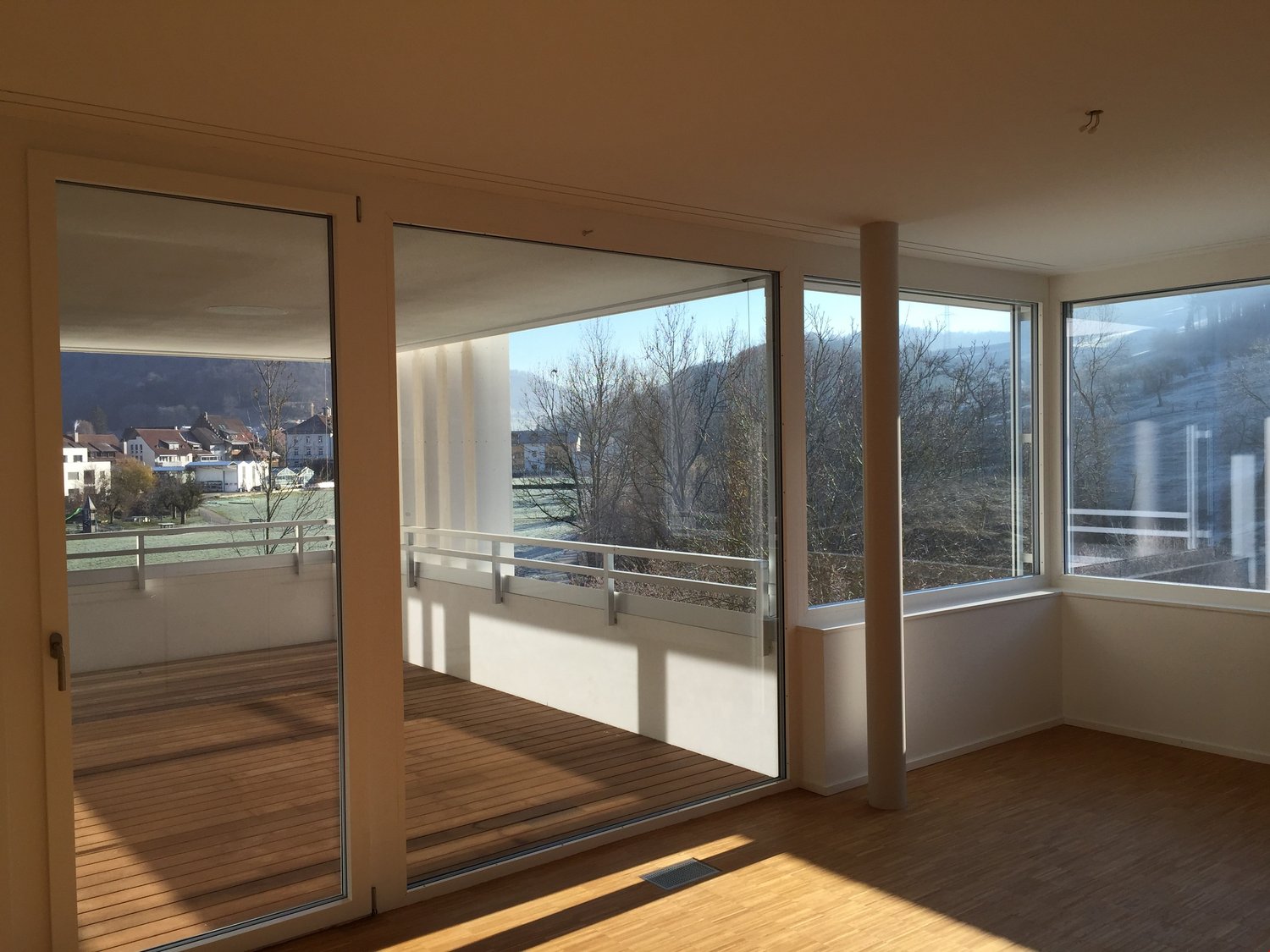 Glass sliding doors, wooden floor, large windows, balcony, modern design, views of the mountains and town
