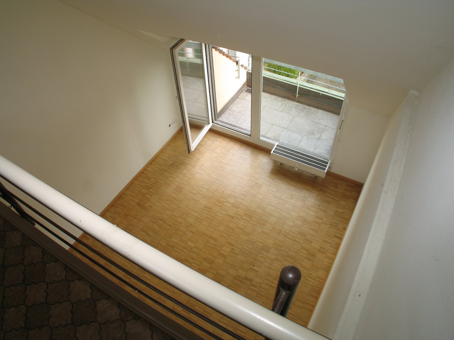 wooden floor, open sliding glass doors, radiator, balcony