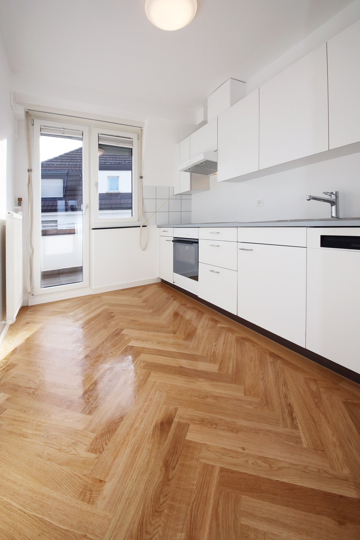 modern white kitchen, wooden floors, glass doors, electrical outlet, dishwasher
