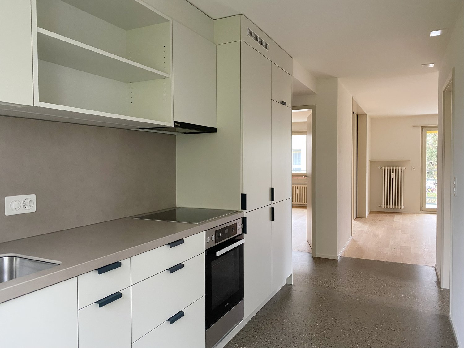 modern kitchen, white cabinets, stainless steel appliances, gas stove, dishwasher, washing machine