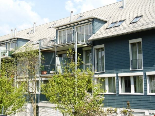 blue residential building with multiple balconies and windows