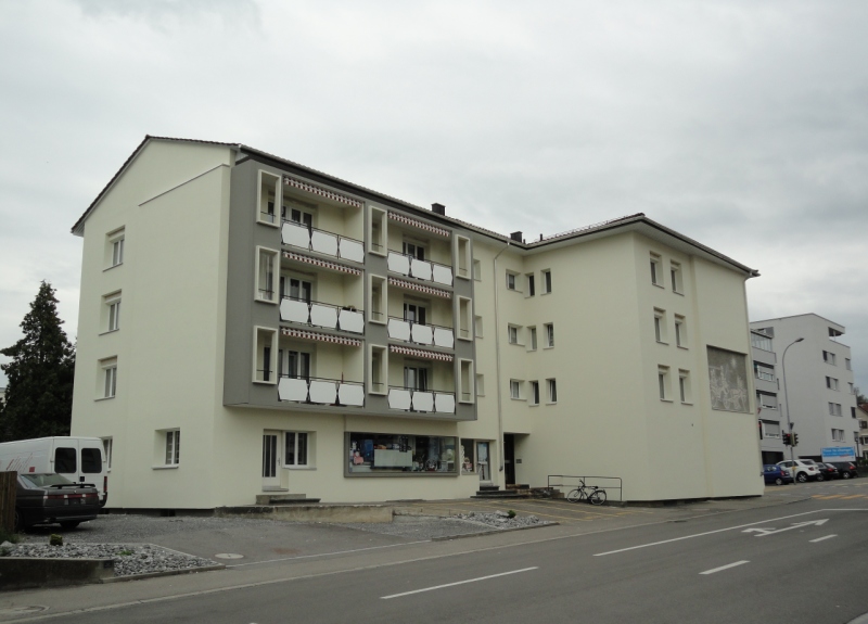 5 story building, white and gray color, balconies, parking place, street view
