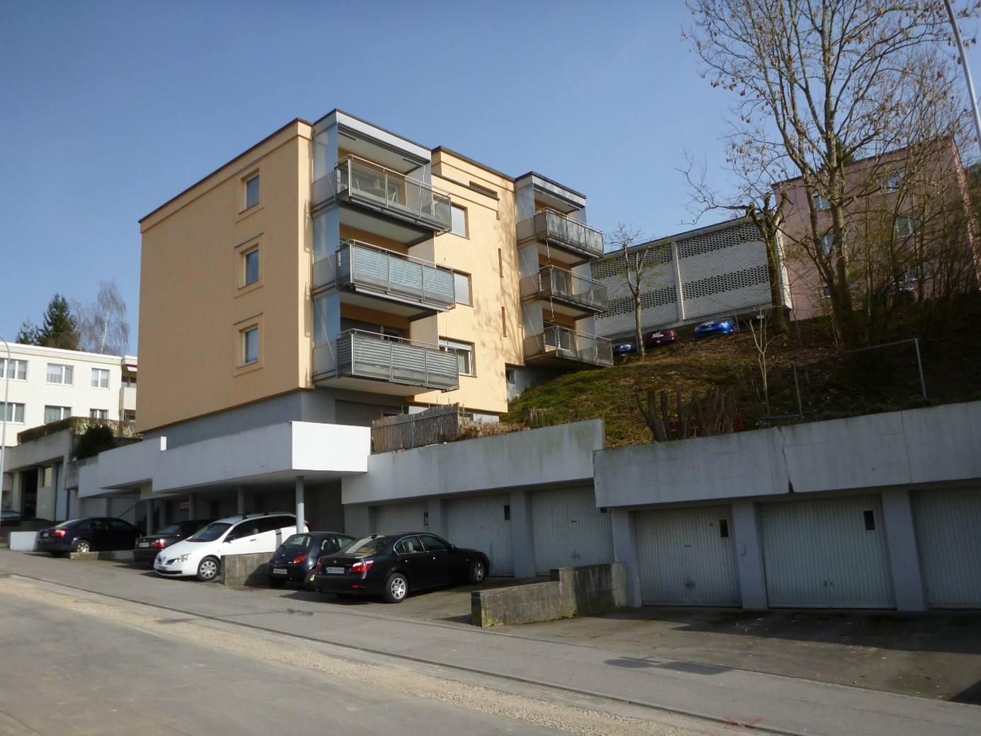 multiple stories, balconies, attached garages, multiple cars parked