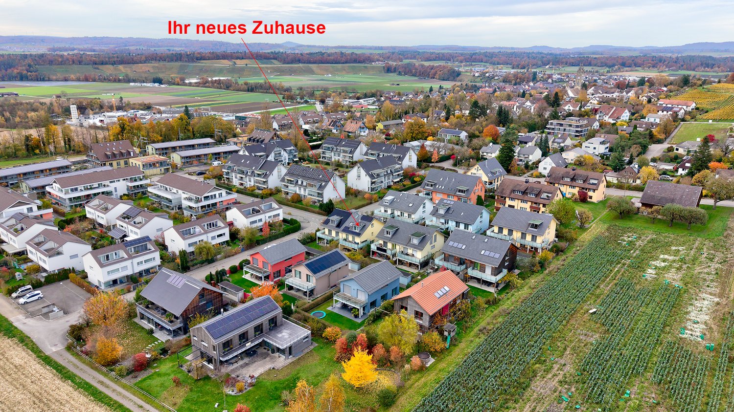 Aerial view of modern residential homes, each with its unique color, multiple homes equipped with solar panels on the roofs, and some houses featuring a garage