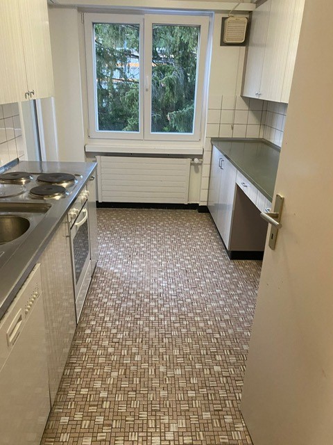 kitchen with tiles, cabinets, sink, stove, oven, white walls