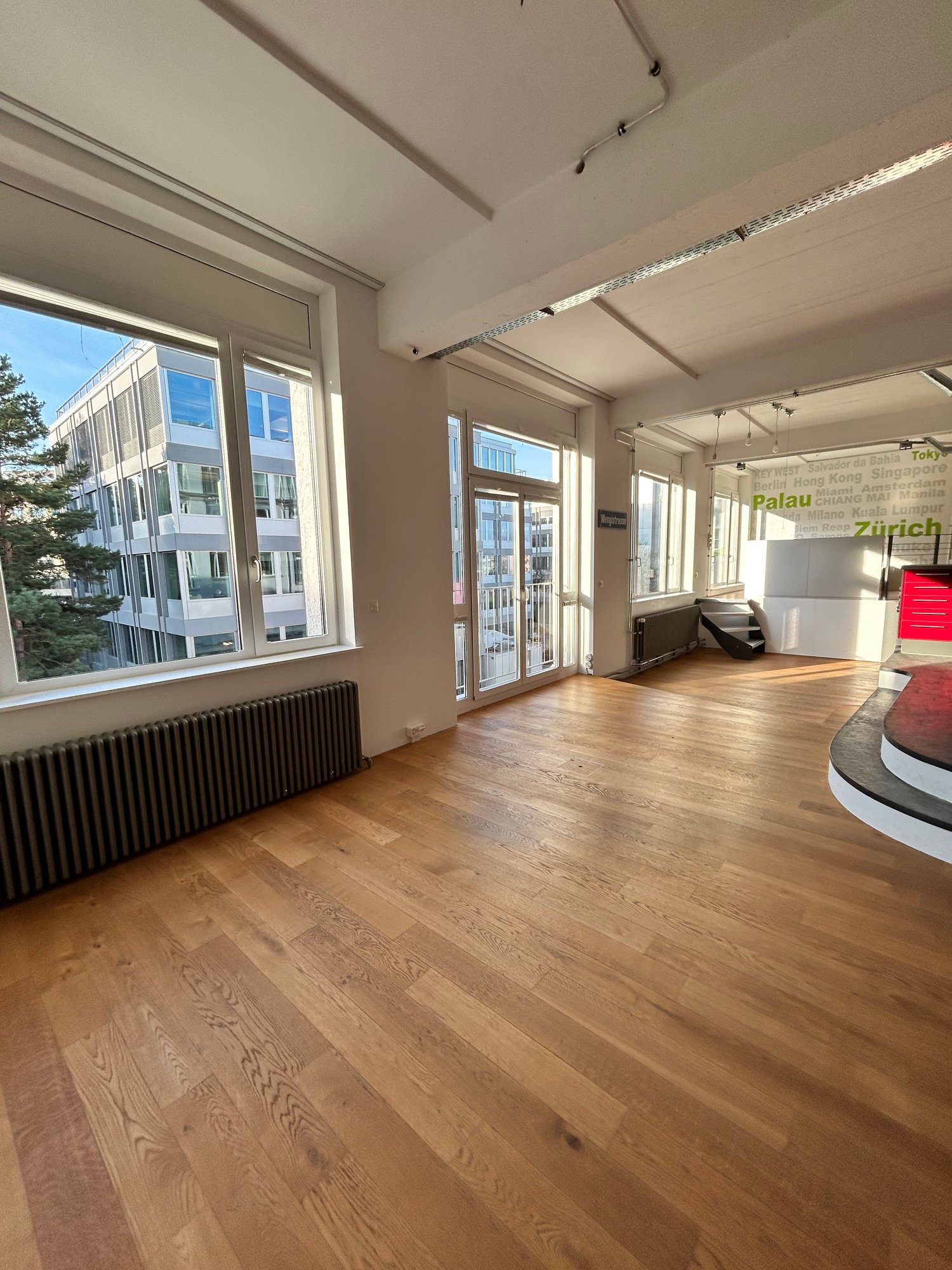 Spacious open room, hardwood floors, large windows, glass doors, radiators, office area