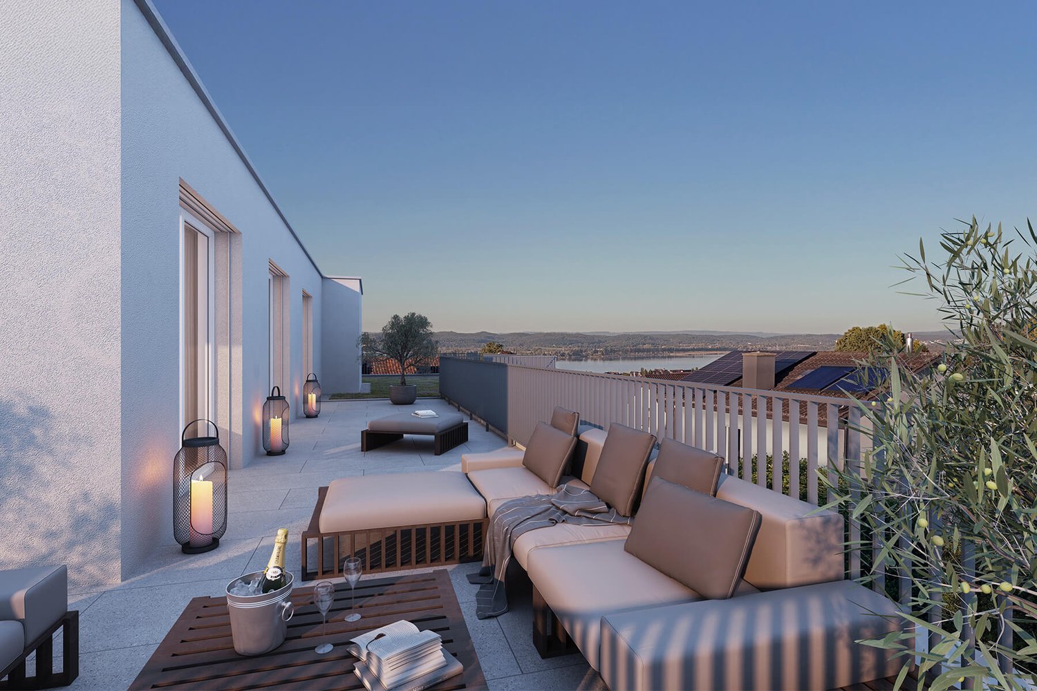 Outdoor sofa set, white railing, balcony, table, wine glasses, bottle, lantern, plant, view