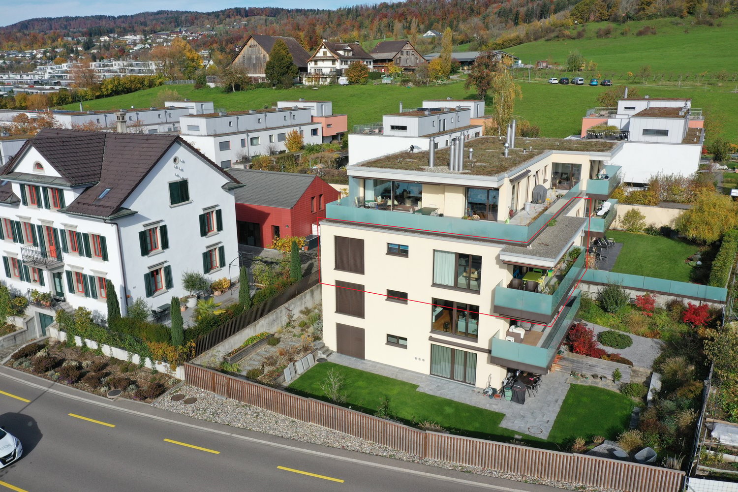 4 story building, modern style, multiple balconies, green rooftop, outdoor seating area, nearby green space