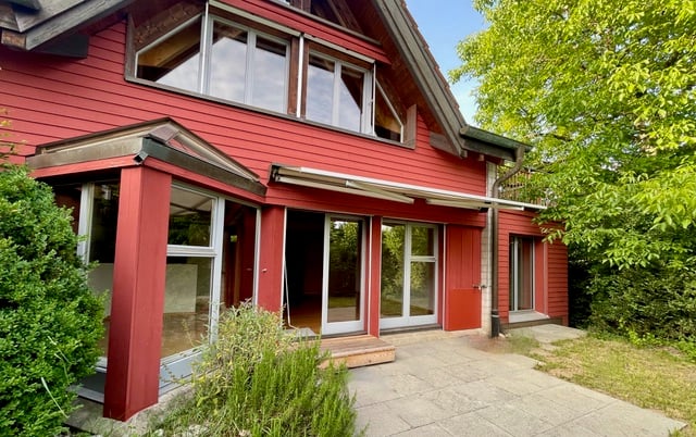 2-story house, red exterior, large windows, glass doors, terrace