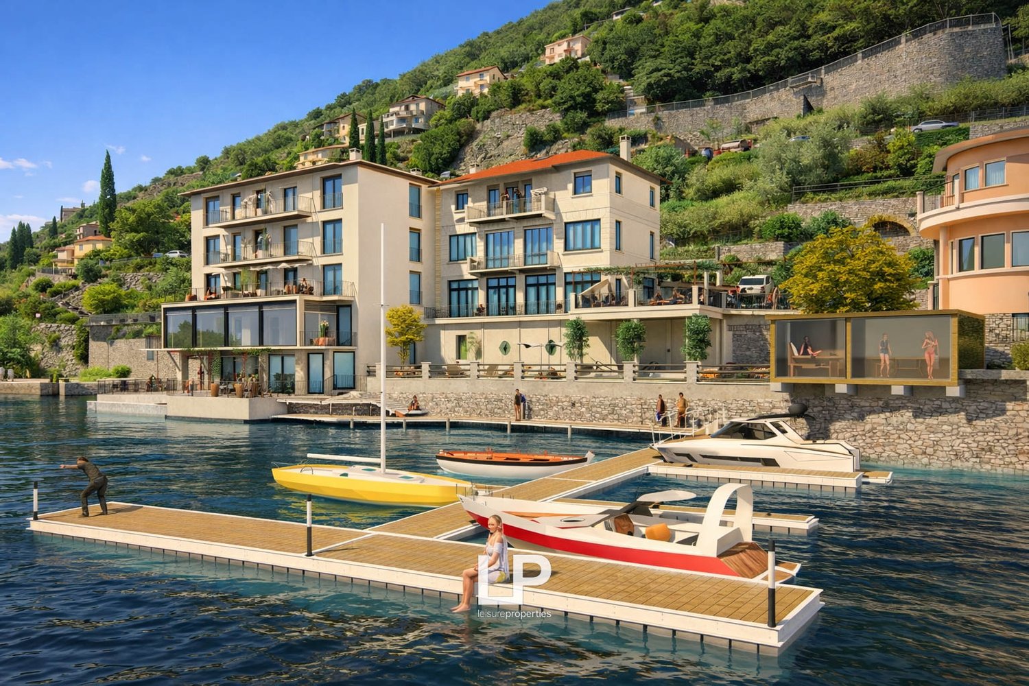 Building with multiple floors and terraces overlooking water, boats docked in front