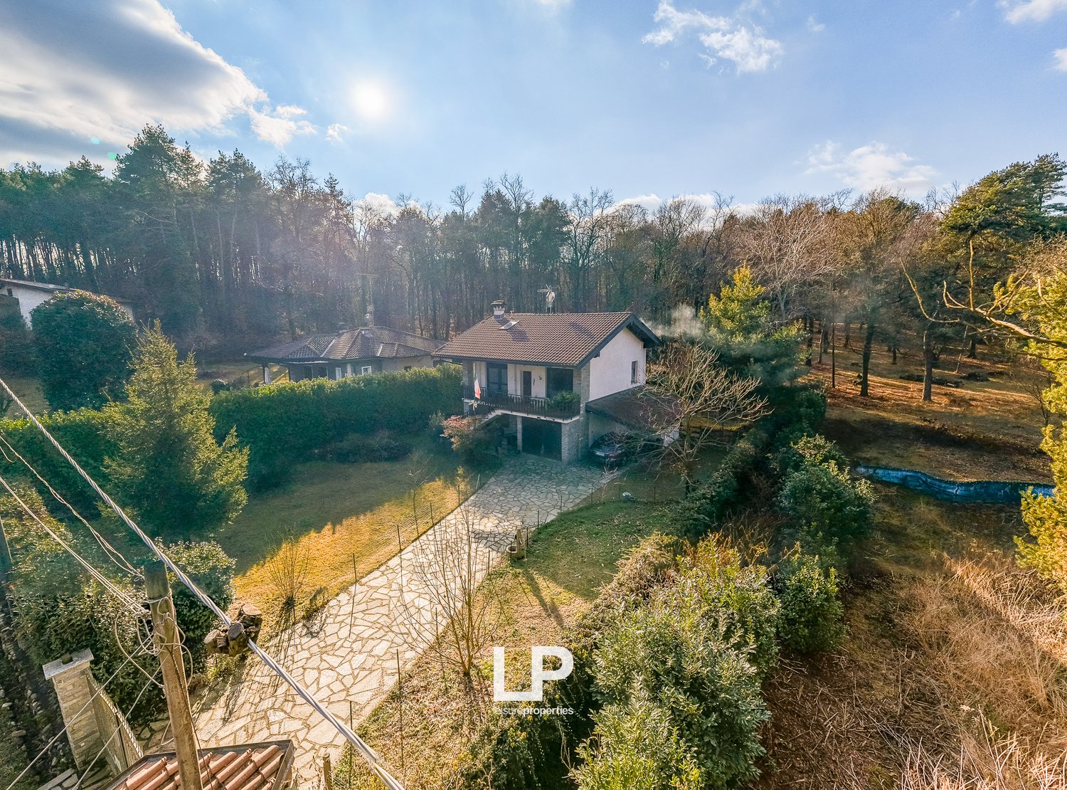 Detached house with garage, aerial view, surrounded by forest