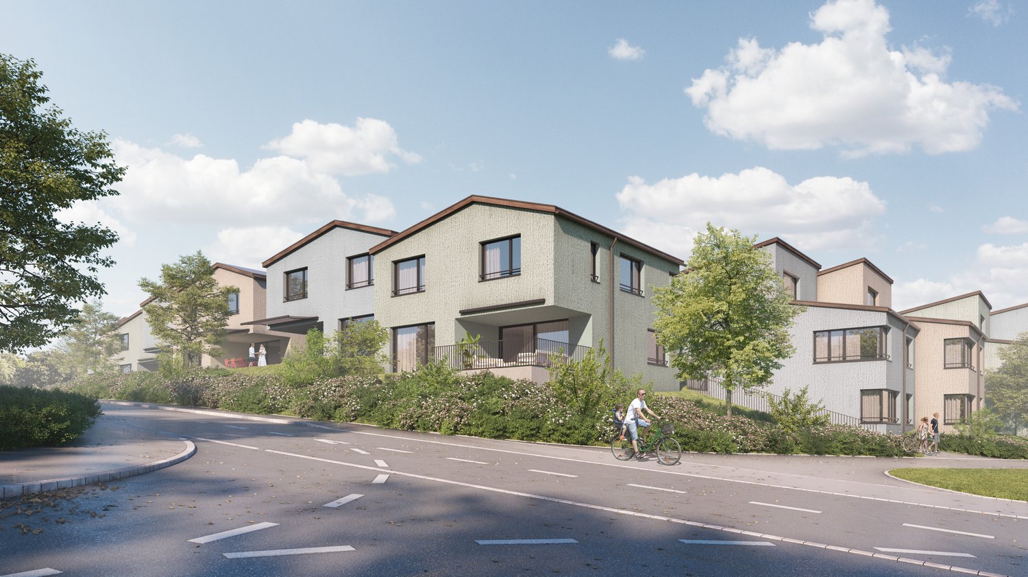 Modern multi-story townhouses, each with a balcony, white walls, brown roofs, greenery around, road with traffic markings.