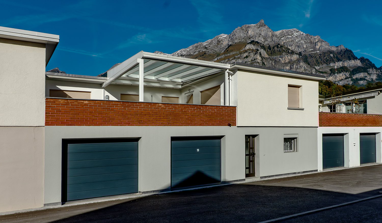 Row of houses with garage, balcony, brick design