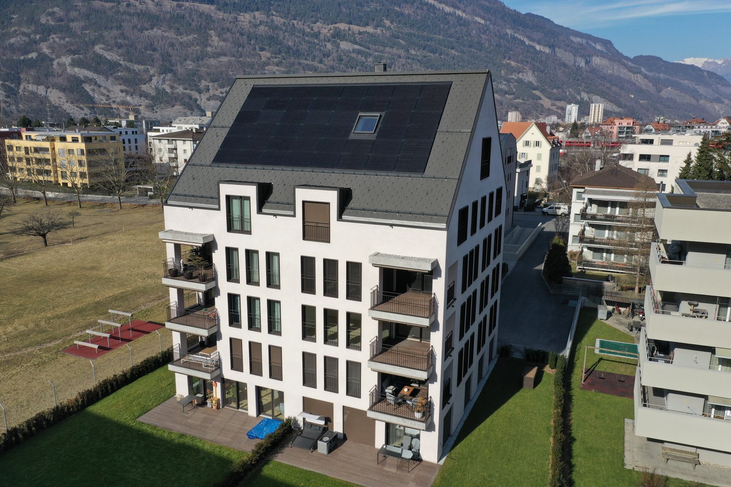 solar panels, balconies, ground level garden, parking, playground, modern architecture