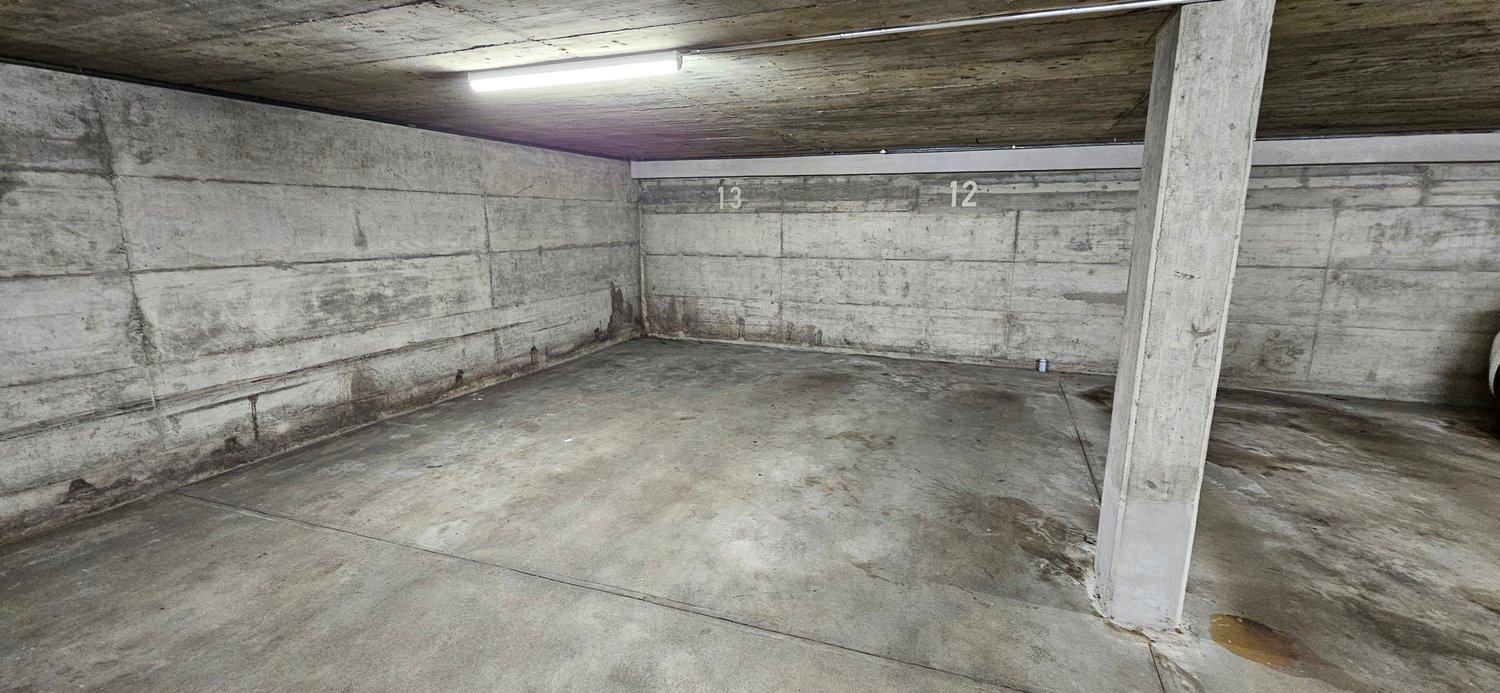 concrete floor, concrete walls, light fixture, labeled number 12 and 13