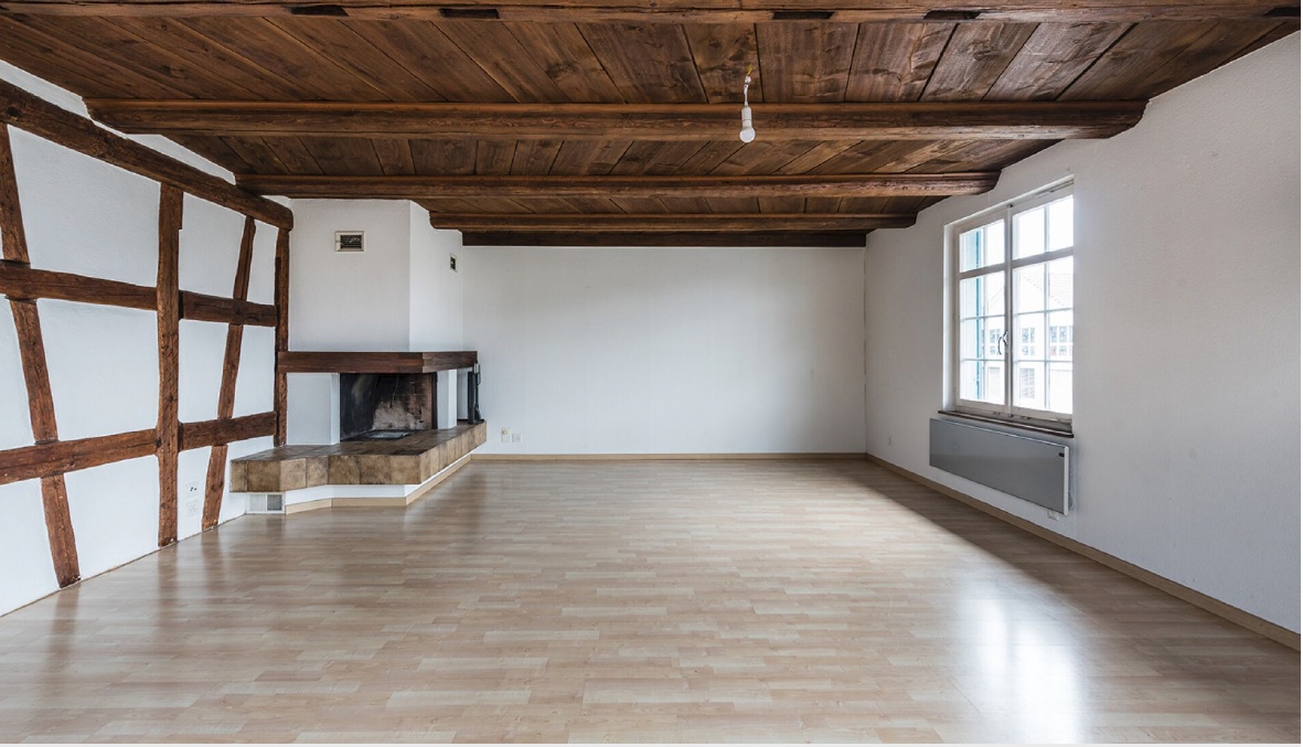 large room, wooden floor, wooden ceiling, fireplace, window