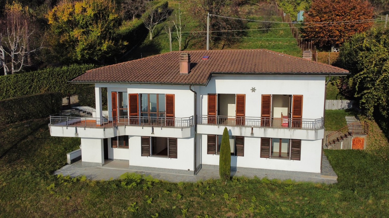 two story house, white, brown roof, windows, balcony, garden