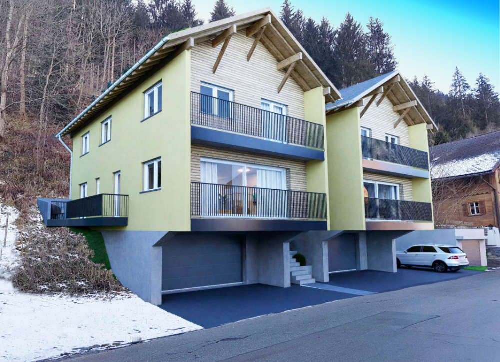 2-story house with balconies, yellow exterior, garage, concrete parking, snow nearby