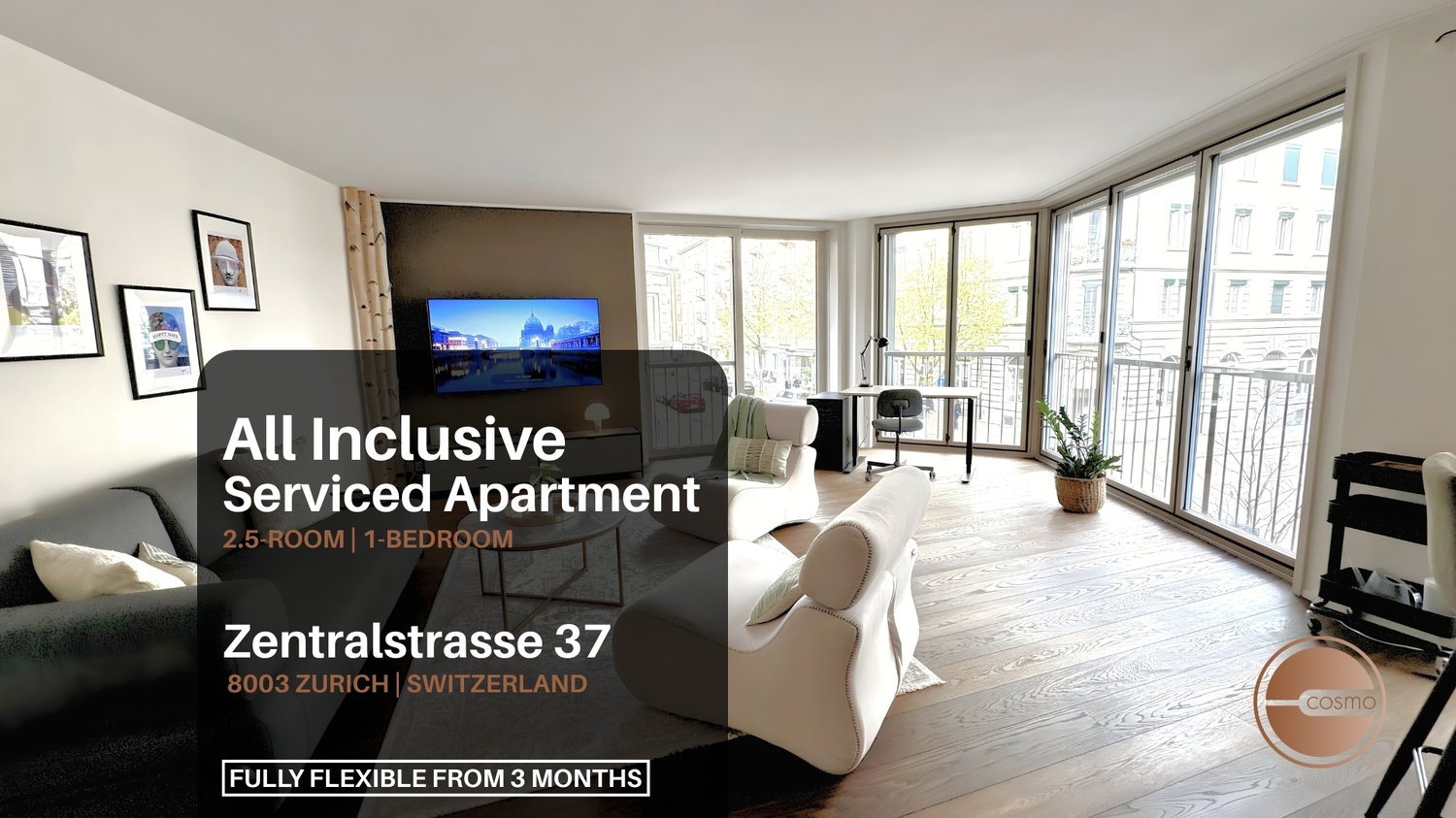 Living area with couches, TV, glass windows, balcony with metal railings, wooden flooring