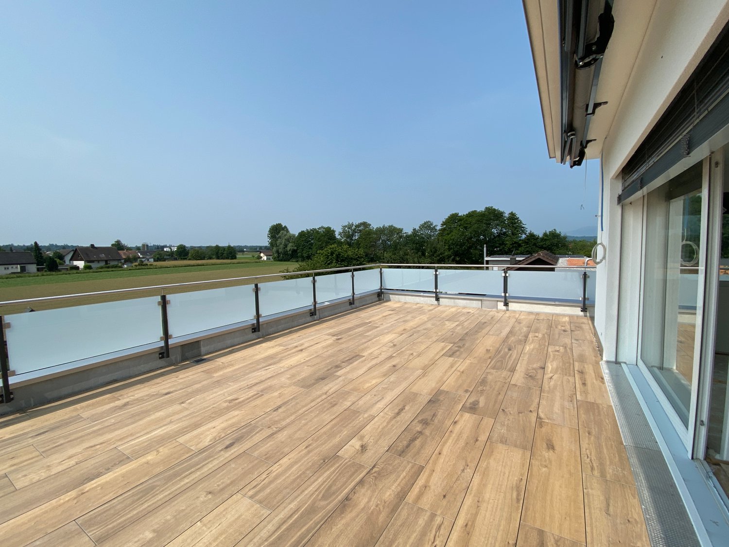 wooden floor, metal railing, view of landscape