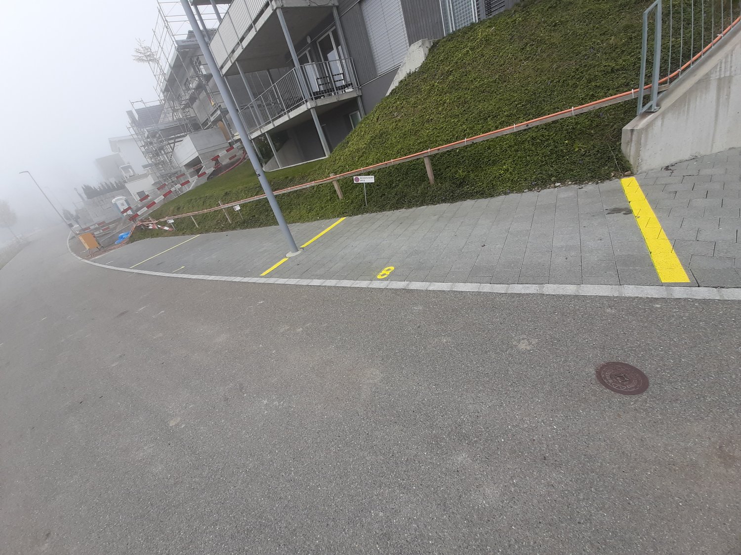 Road with sidewalk with designated parking places
