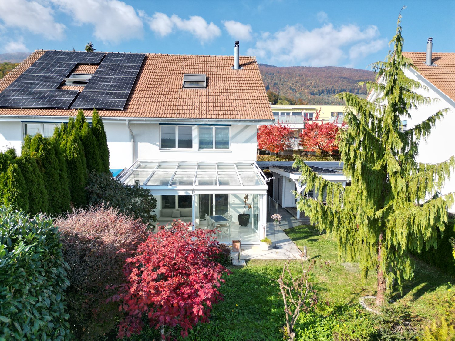 3 story house, white walls, red roof, solar panels, conservatory, garden, view