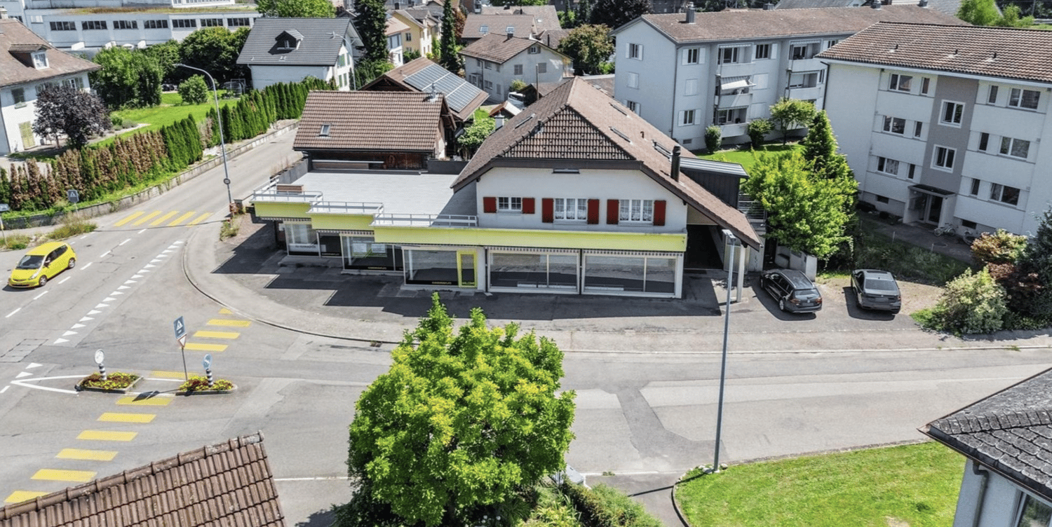 House: single family house, red brick, brown roof, glass windows, solar panels, garage, street with cars
