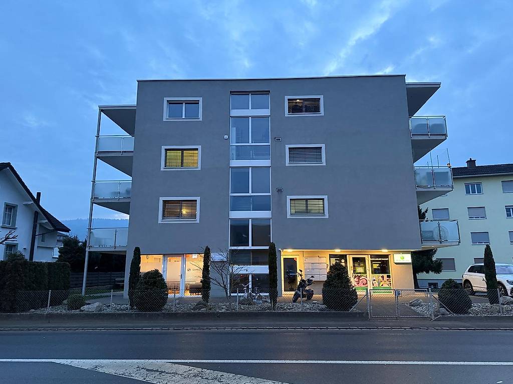 modern 3 story building with balconies and glass windows