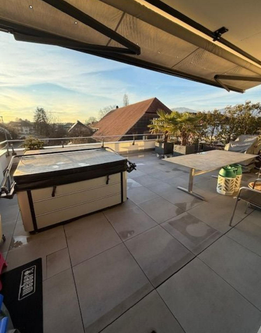 tiled terrace, covered with awning, hot tub, table, palm trees, mountain view