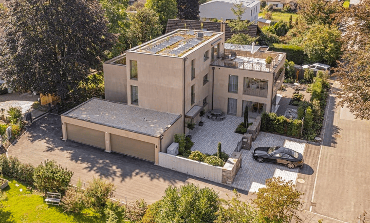 3 story house, solar panels on the roof, garage, car parked in front, garden, trees