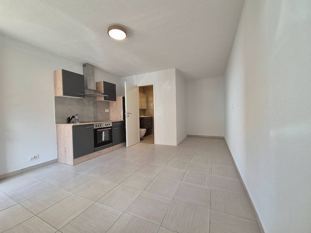 Empty kitchen, white tiles, wooden cabinets, built-in oven, countertop, sink, white walls